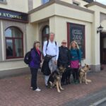 Ireland Mike Gena and Sweetmans with 3 dogs in front of Achill Sound Hotel